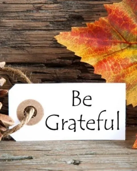 autumnal background with a label with be grateful on it