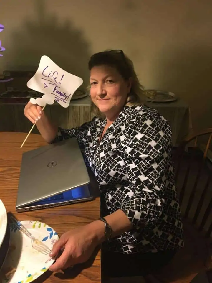 A person sitting at a table using a laptop