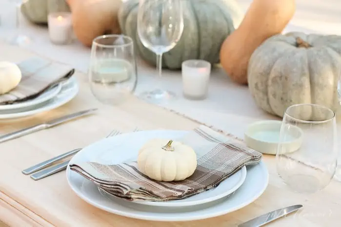 A plate of food and glasses of wine on a table, with Thanksgiving and Pumpkin