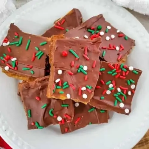 A pile of chocolate brownie bars with red, green, and white sprinkles.