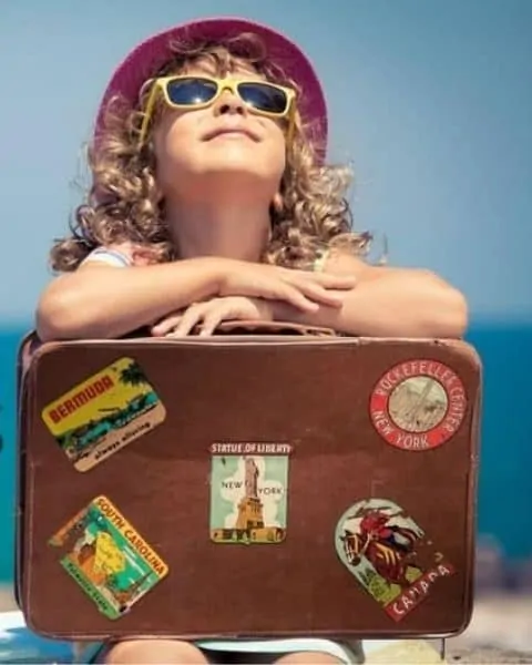 educational vacations with a girl holding her suitcase for traveling the world