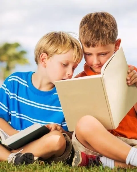 two boys reading books together
