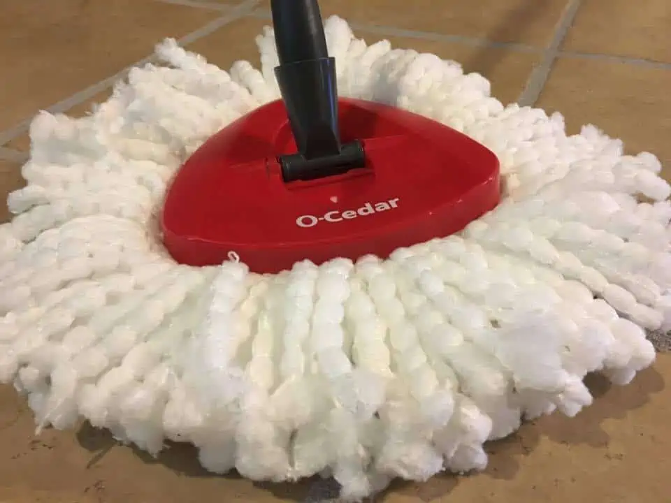 A close up of the O-cedar easy wring spin mop.