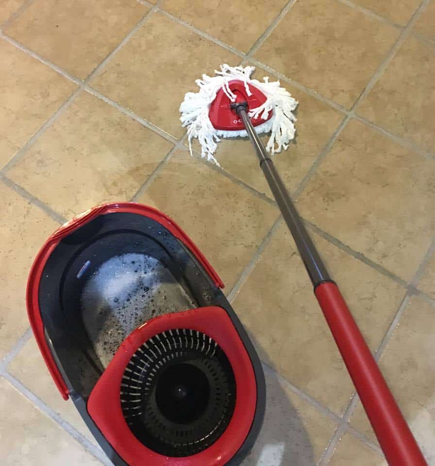 O-cedar easy wring spin mop cleaning a kitchen floor.