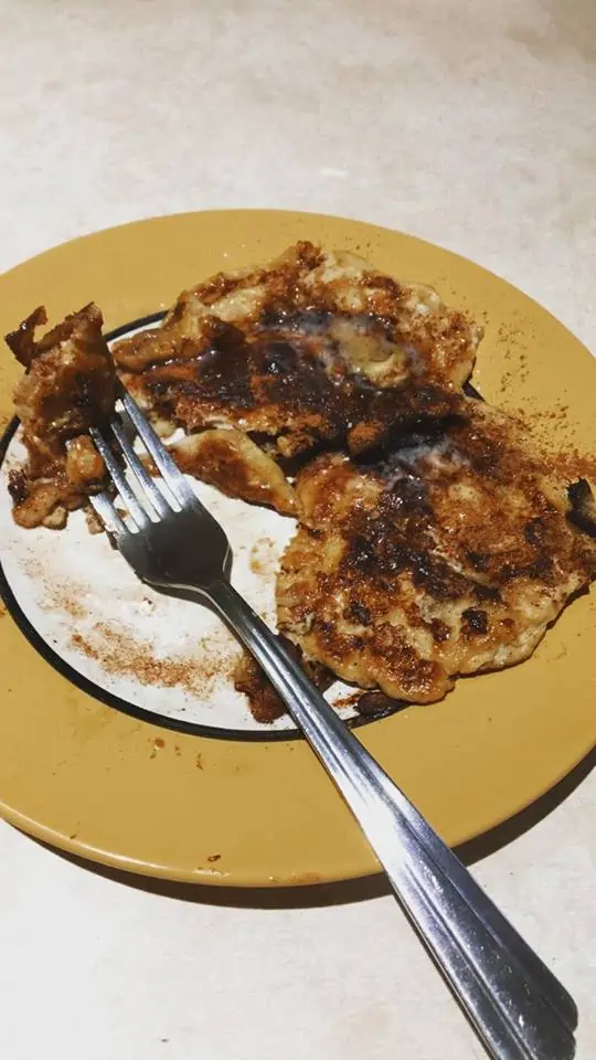 A plate of food with a fork and knife, with Pancake