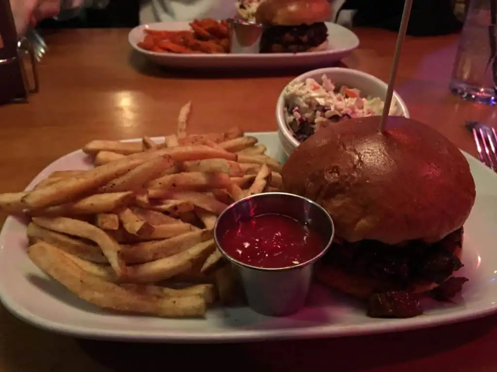 A plate of food with a sandwich and fries on a table