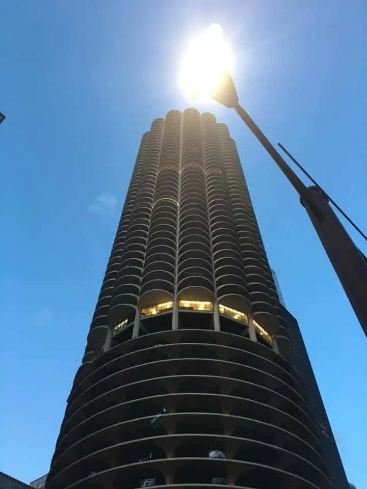 A large, tall parking tower with a sky background