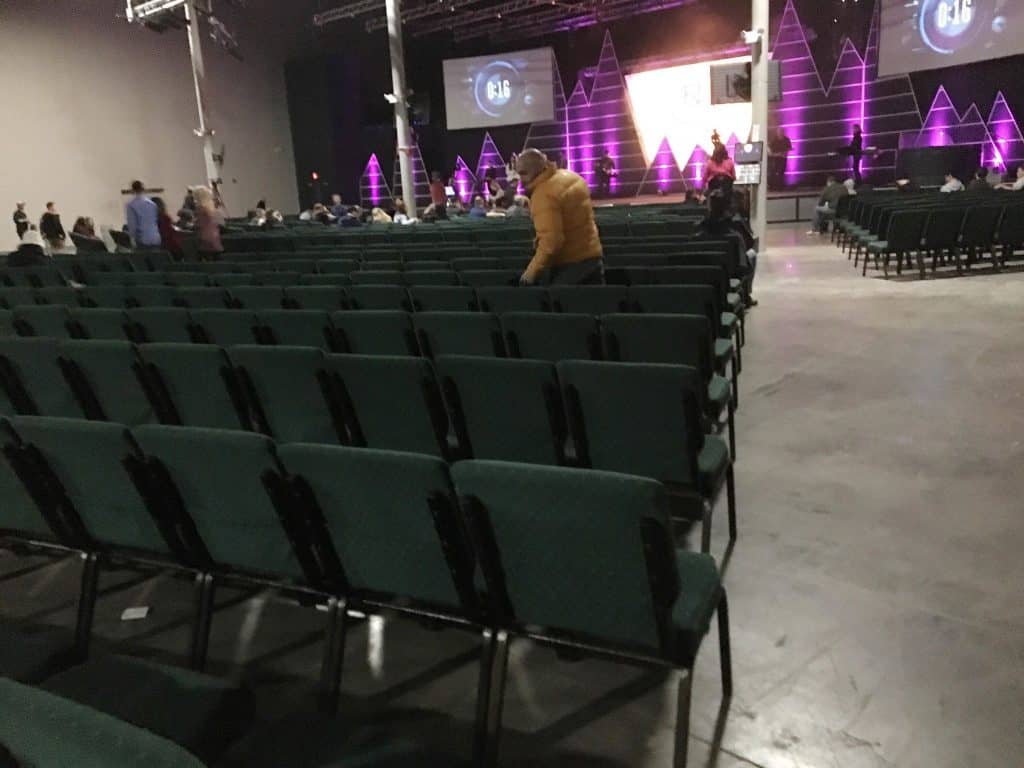 A church room full of people and chairs.