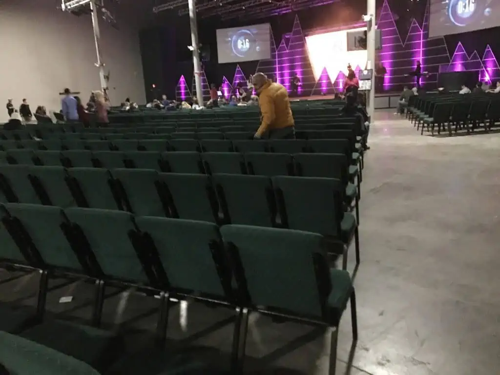 A church room full of people and chairs.