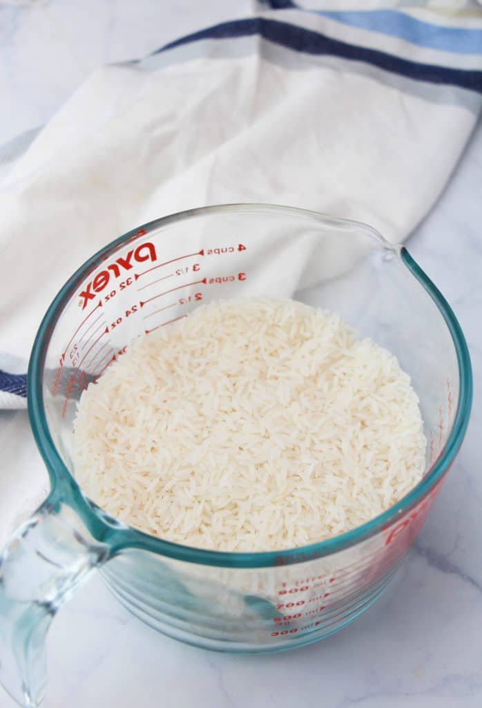 Measuring cup full of rice.