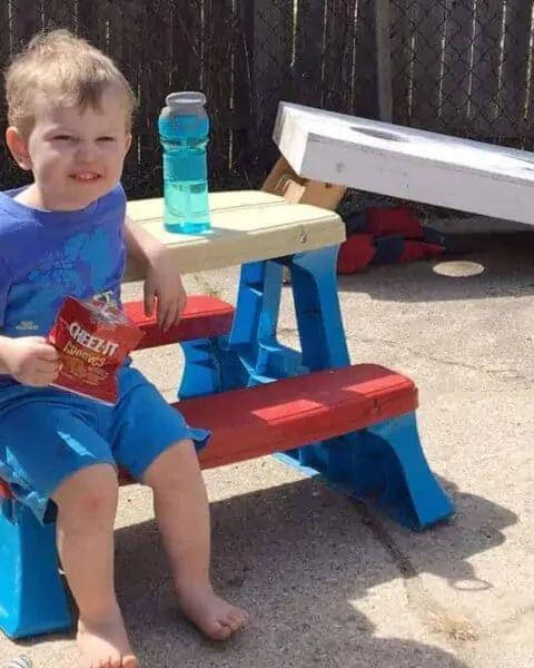 A little boy sitting on a bench