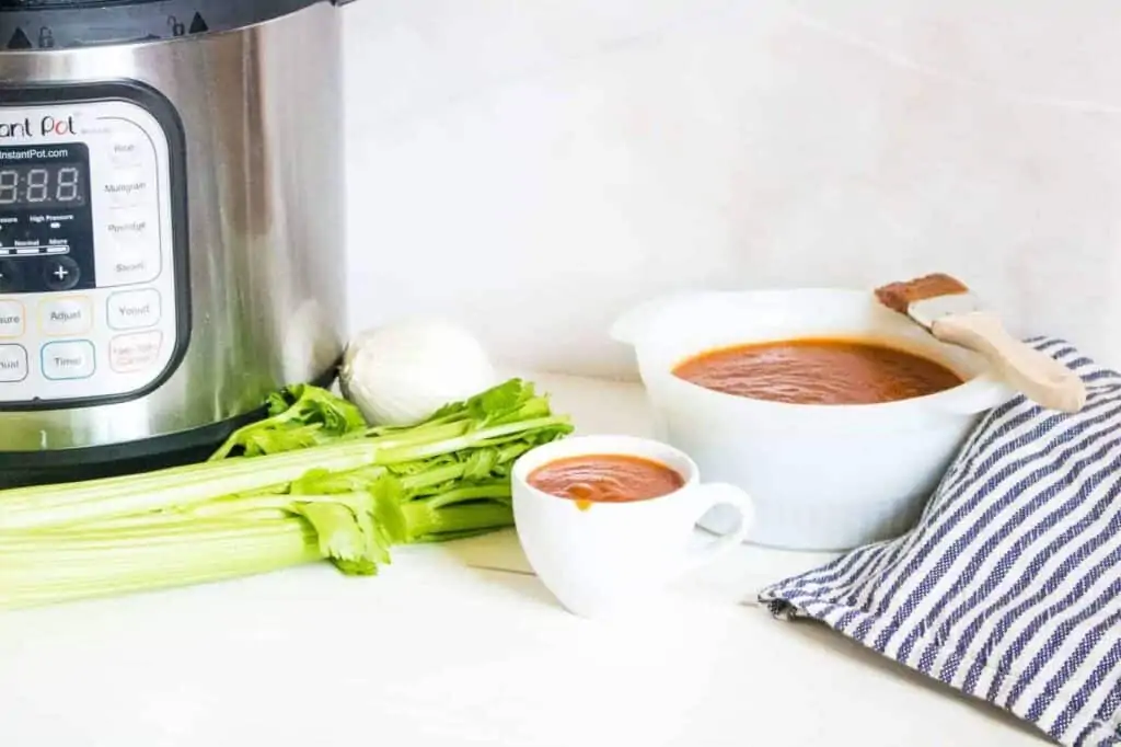 A clean table with bowls of homemade BBQ sauce.