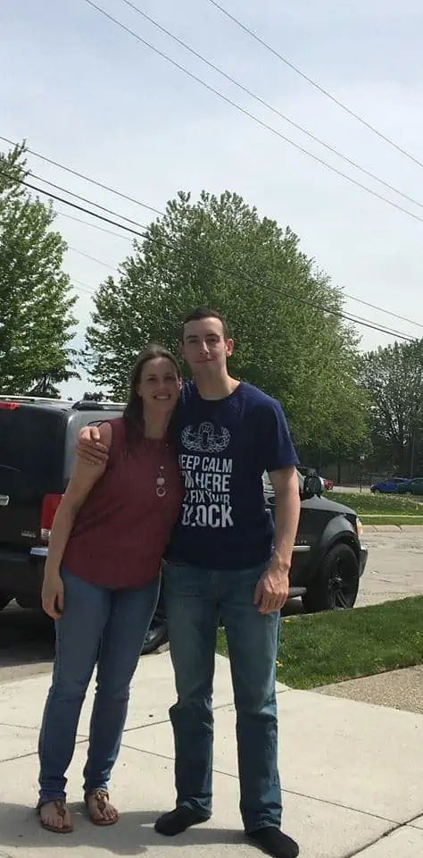 A man and a woman standing in a parking lot