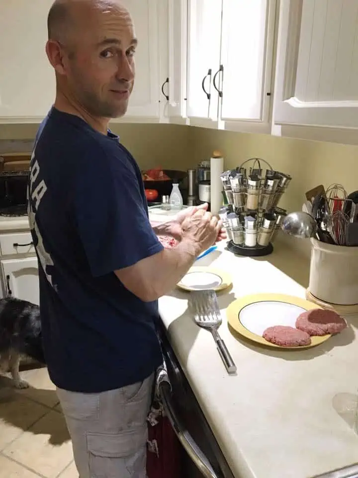 A person standing in a kitchen preparing food