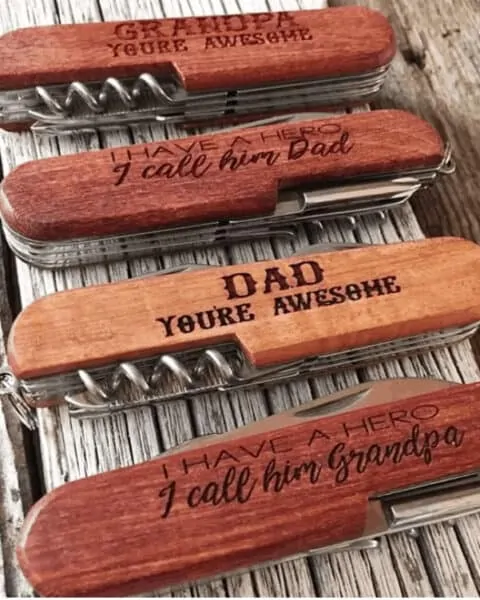 set of four different wooden knives that are personalized for Father's Day.