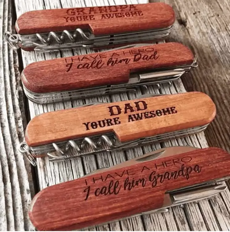 set of four different wooden knives that are personalized for Father's Day.