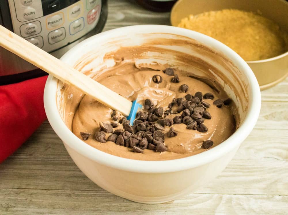 Mix chocolate chips into cheesecake.