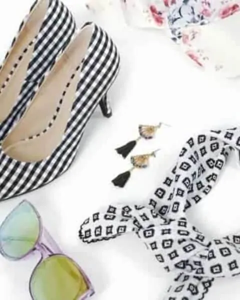 heels, sunglasses, scarf, hat, earrings sitting on a white background