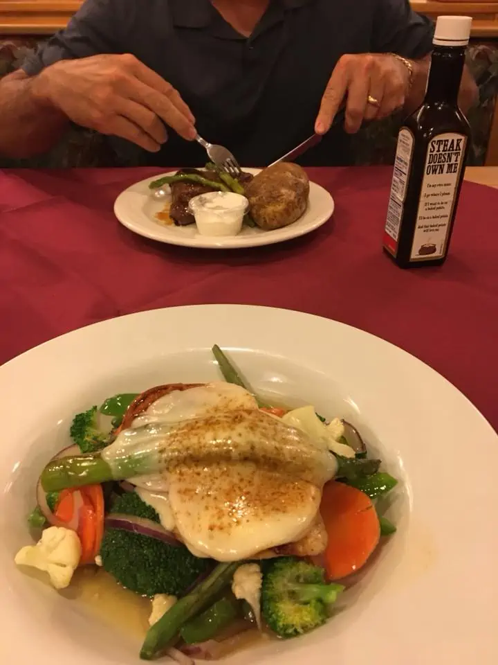 A person sitting at a table with a plate of food. The Bavarian Inn Summertime Edition