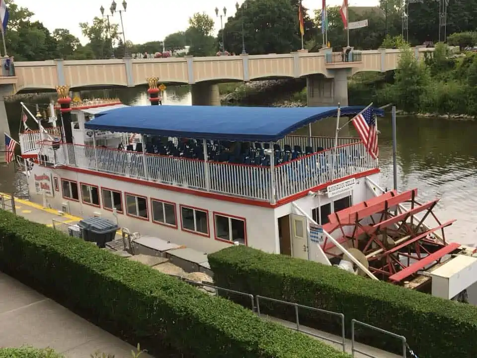 A small boat in a body of water. The Bavarian Inn Summertime Edition