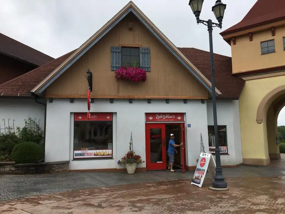 A group of people in front of a house. The Bavarian Inn Summertime Edition