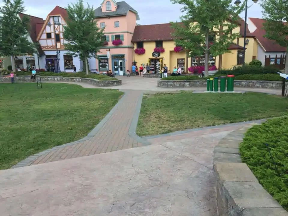 A small house in the middle of a sidewalk. The Bavarian Inn Summertime Edition