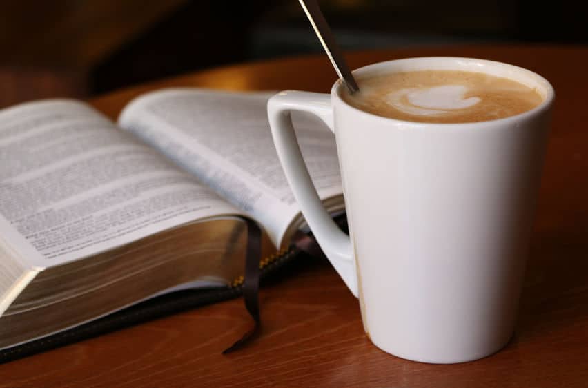 Cup of coffee and open book.