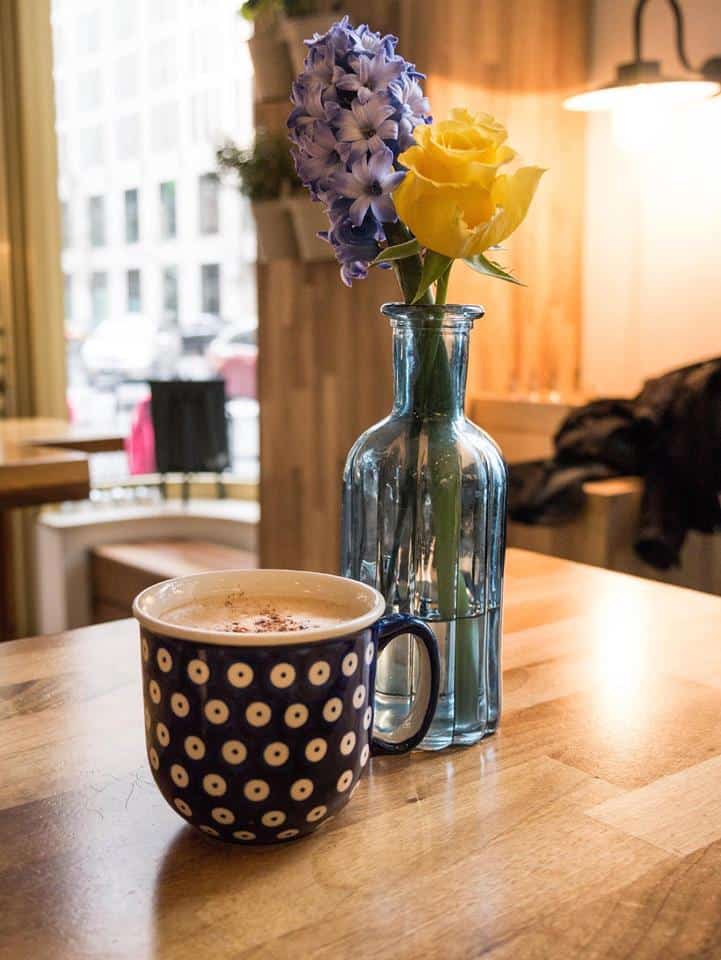 Beautiful flowers and cup of warm coffee.