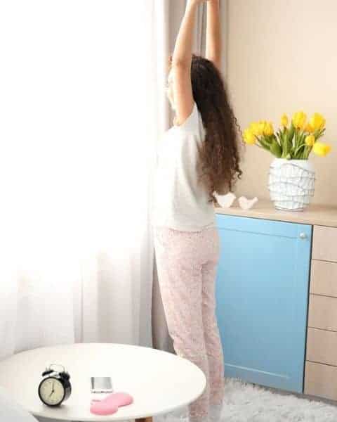 Woman stretching after waking up in the morning.