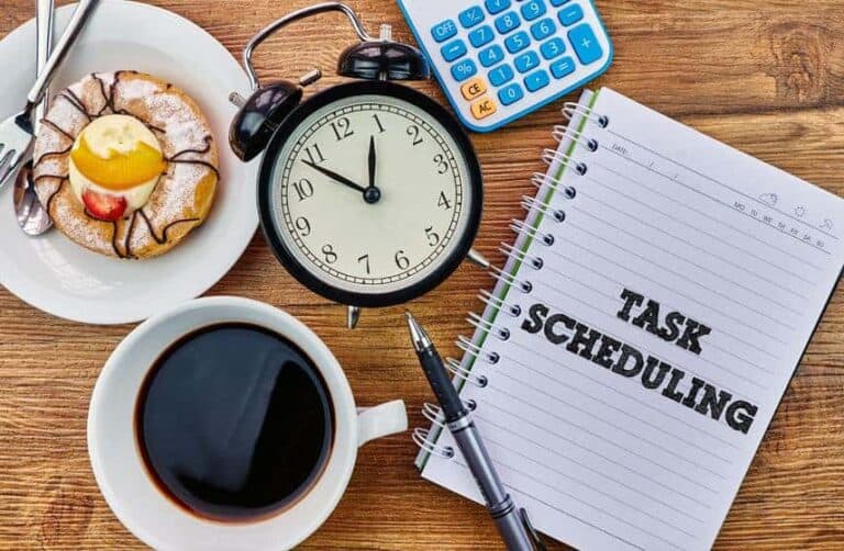 A breakfast layout with donuts, clock, morning coffee, and a notebook of notes.