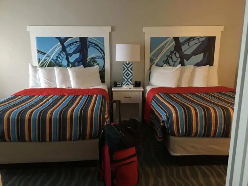 A bedroom with a bed and a chair in a room. My Stay at Hotel Breakers Cedarpoint