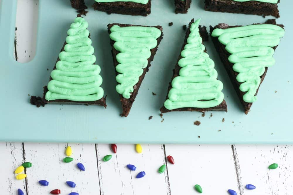 Green frosting on chocolate brownie Christmas trees.