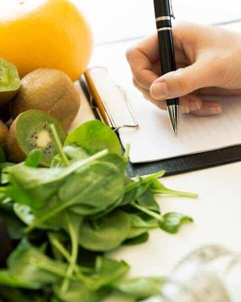 woman writing down a meal plan
