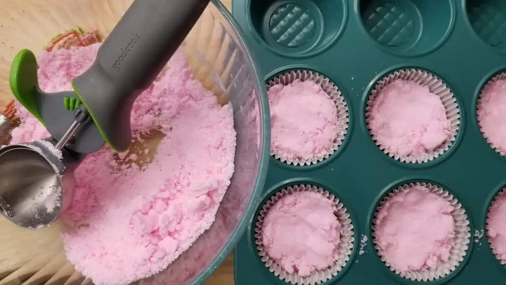 Scoop the bath bombs into the molds.