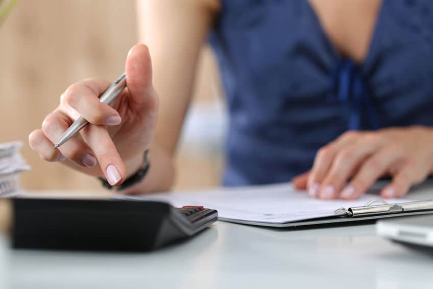 woman writing out a financial budget plan