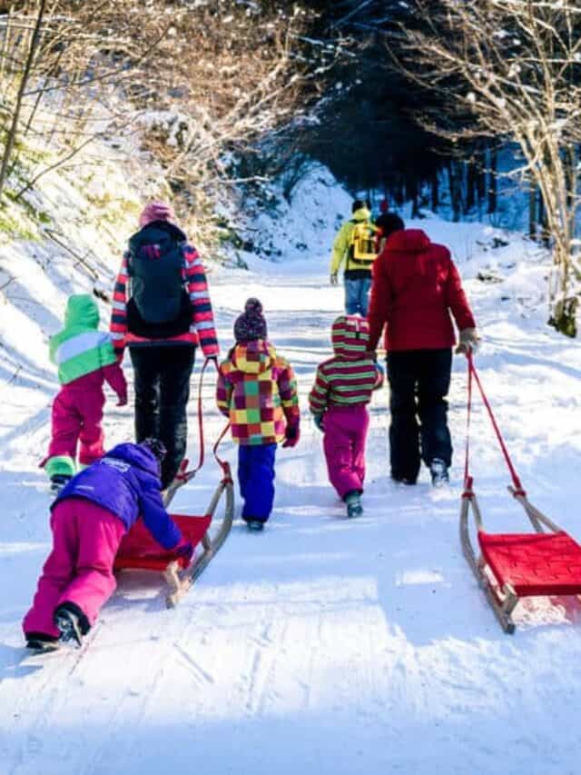 A family walking together to go winter sledding