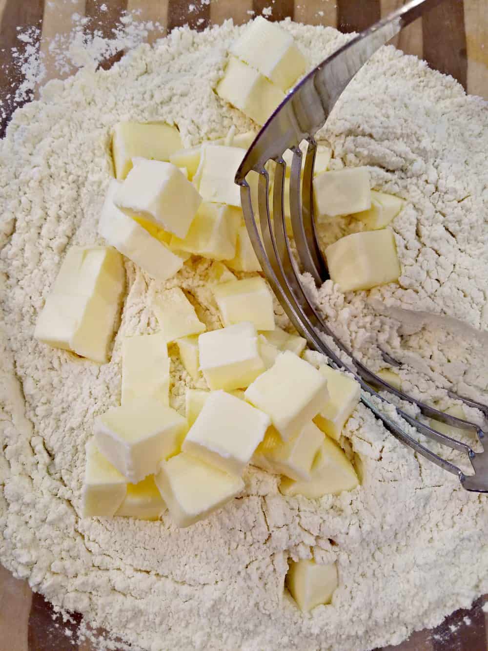 Mix butter into flour in the homemade biscuit recipe. 