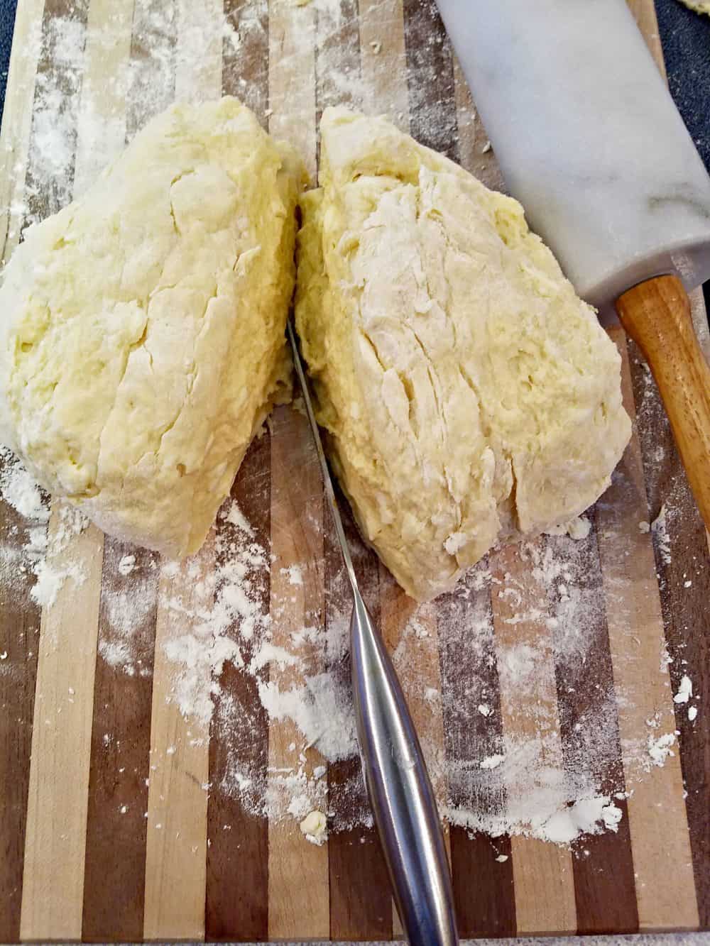 Biscuit dough cut in half from a Homemade Buttermilk Biscuits recipe.