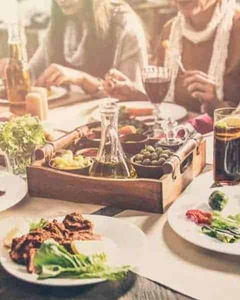 people sitting around a table eating dinner