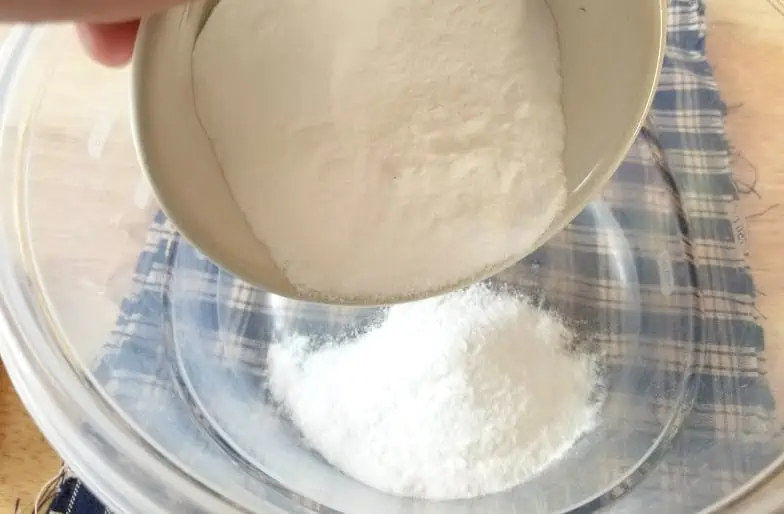 Add baking soda to a small glass bowl to make an easy soft scrub cleaner.