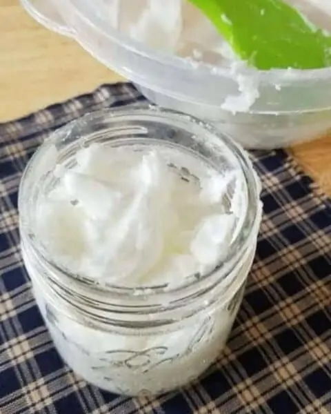 A mason jar of homemade soft scrub recipe.