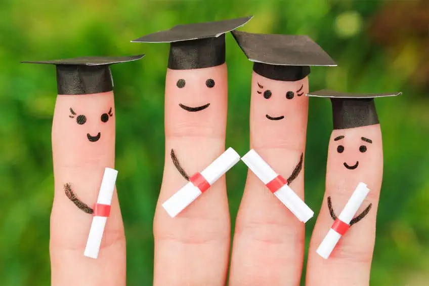Finger models dressed as graduates holding the diploma. 