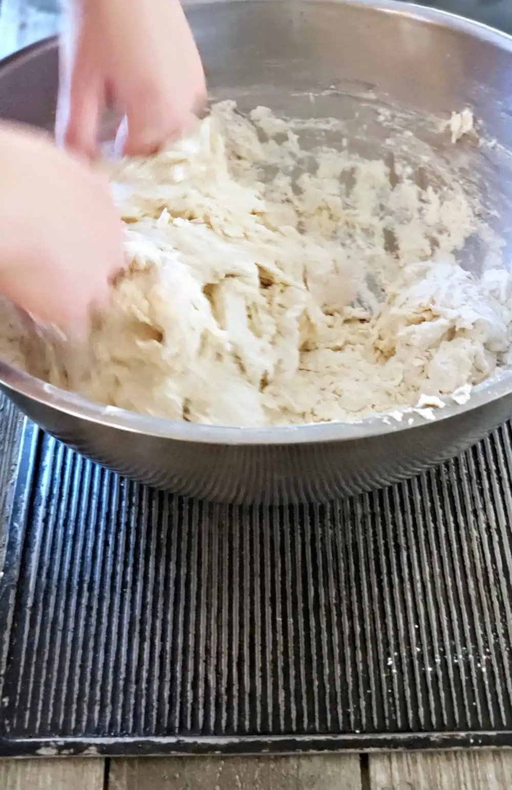Mix flour to make dough for homemade bread.