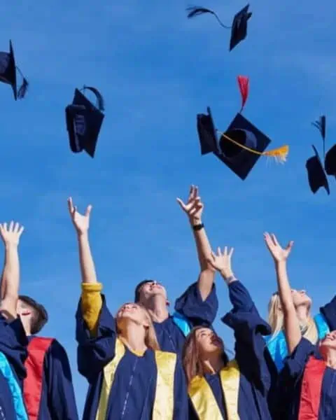 A group of college graduates throwing up their hats.