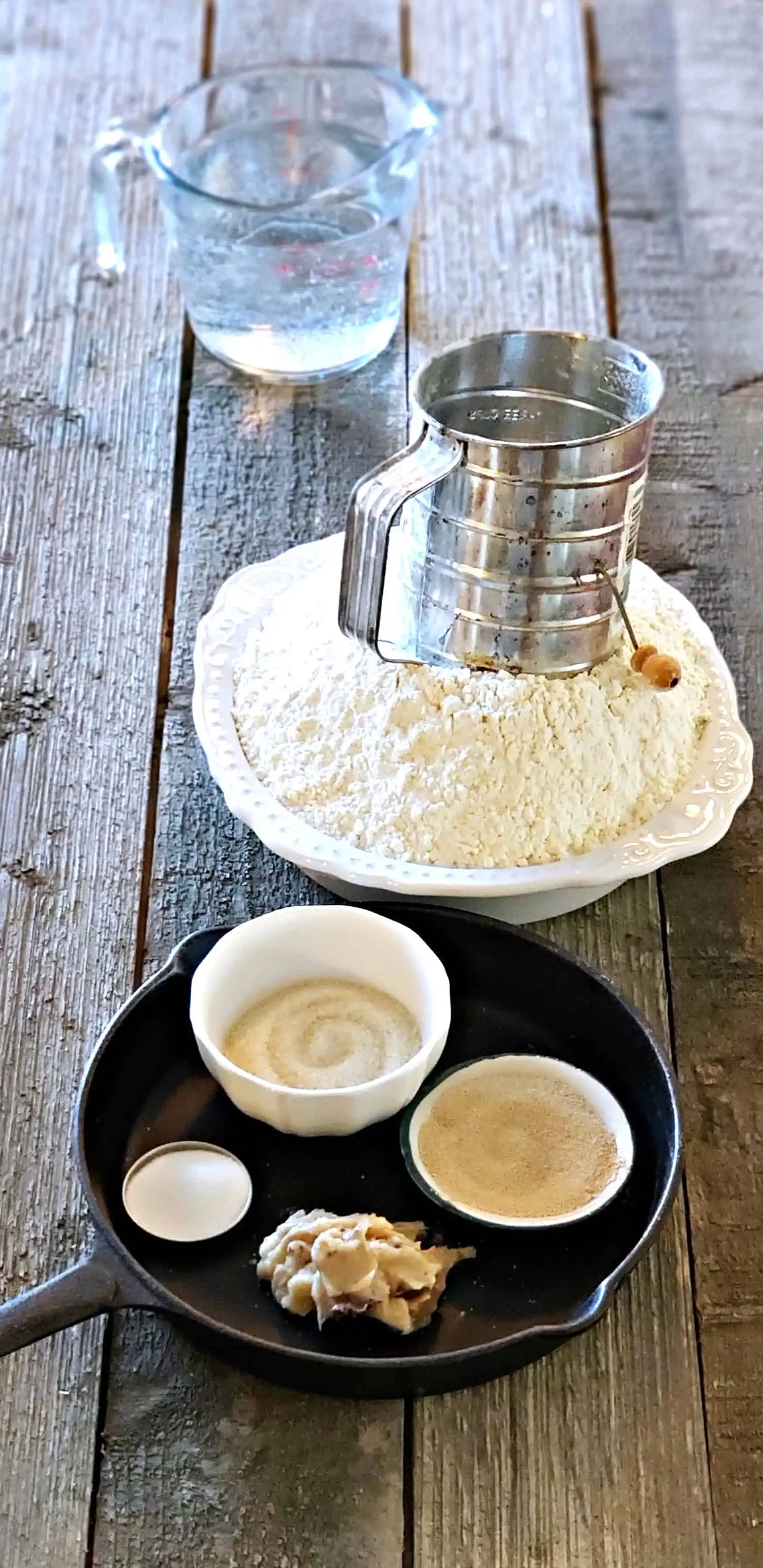 A cup of coffee sitting on top of a wooden table, with Homemade bread