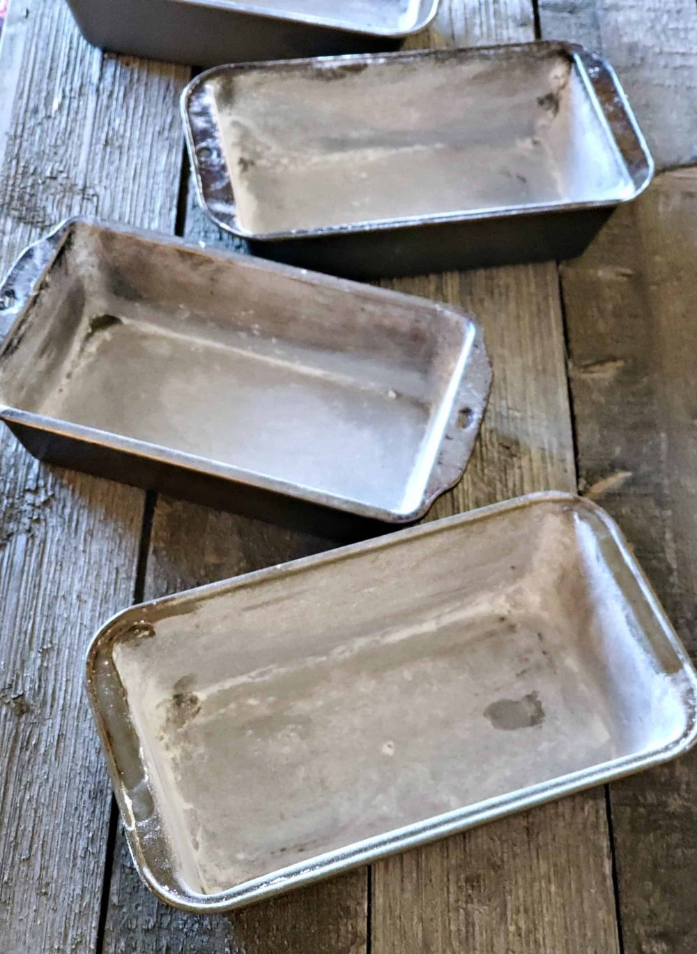 Prepare 4 bread pans for homemade bread dough.