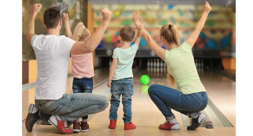 Parents and children bowling.