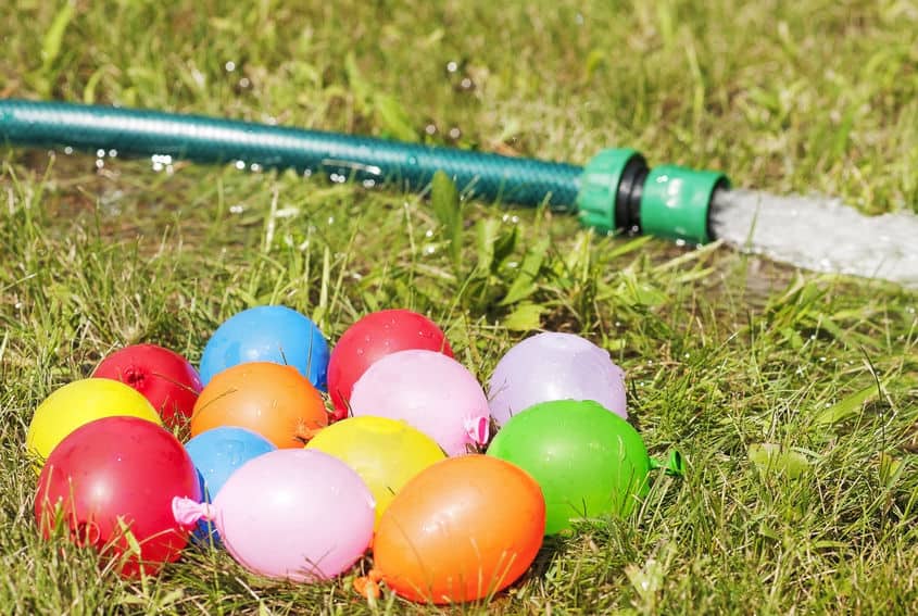 Water balloons and garden hose for summer fun.