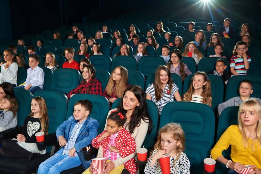 Families and groups of kids gathered to watch free movies in the movie theater.