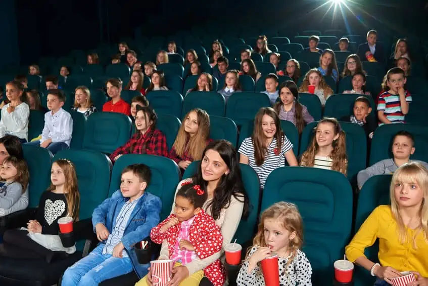 Families and groups of kids gathered to watch free movies in the movie theater.